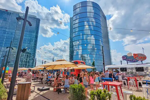 Guests enjoying a sunny day on the Perch Putt rooftop