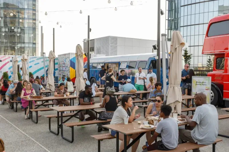 Groups gathering at outdoor tables on The Perch