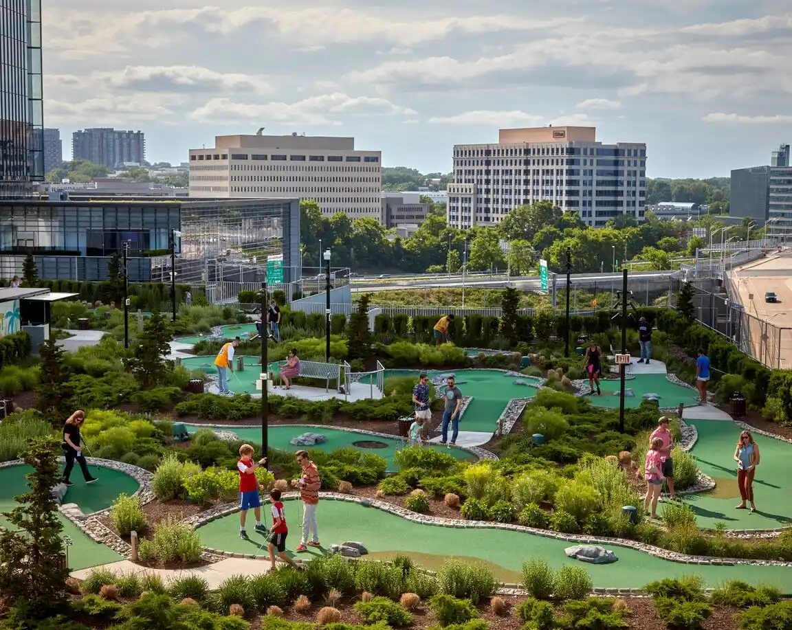 Guests playing the rooftop mini golf course at Perch Putt